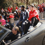 
              Georgia offensive lineman Sedrick Van Pran, left, and quarterback Stetson Bennett, right, ride by fans during a parade celebrating the Bulldog's second consecutive NCAA college football national championship, Saturday, Jan. 14, 2023, in Athens, Ga. (AP Photo/Alex Slitz)
            