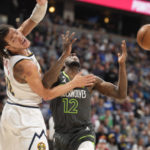 
              Denver Nuggets forward Aaron Gordon, left, reacts after fouling Minnesota Timberwolves forward Taurean Prince as he drives to the net in the first half of an NBA basketball game Wednesday, Jan. 18, 2023, in Denver. (AP Photo/David Zalubowski)
            