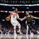 
              New York Knicks guard Jalen Brunson (11) is defended by Toronto Raptors guard Fred VanVleet (23) during the second half of an NBA basketball game Friday, Jan. 6, 2023, in Toronto. (Cole Burston/The Canadian Press via AP)
            