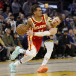 
              Golden State Warriors guard Donte DiVincenzo (0) defends Atlanta Hawks guard Trae Young (11) during the second half of an NBA basketball game in San Francisco, Monday, Jan. 2, 2023. (AP Photo/Jed Jacobsohn)
            