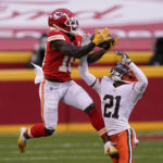
              FILE - Kansas City Chiefs wide receiver Tyreek Hill makes a catch over Cleveland Browns cornerback Denzel Ward (21) during the second half of an NFL divisional round football game, Sunday, Jan. 17, 2021, in Kansas City. The Chiefs could have paid Tyreek Hill handsomely and gone all-in on another championship run. Instead, they dealt him to the Dolphins for a package of draft picks and some financial flexibility. In doing so, they took a championship window that might have lasted a few years and extended it by several more. It was a difficult decision, though, and one the Bengals – their opponent in Sunday’s AFC title game – will soon face. (AP Photo/Charlie Riedel, File)
            