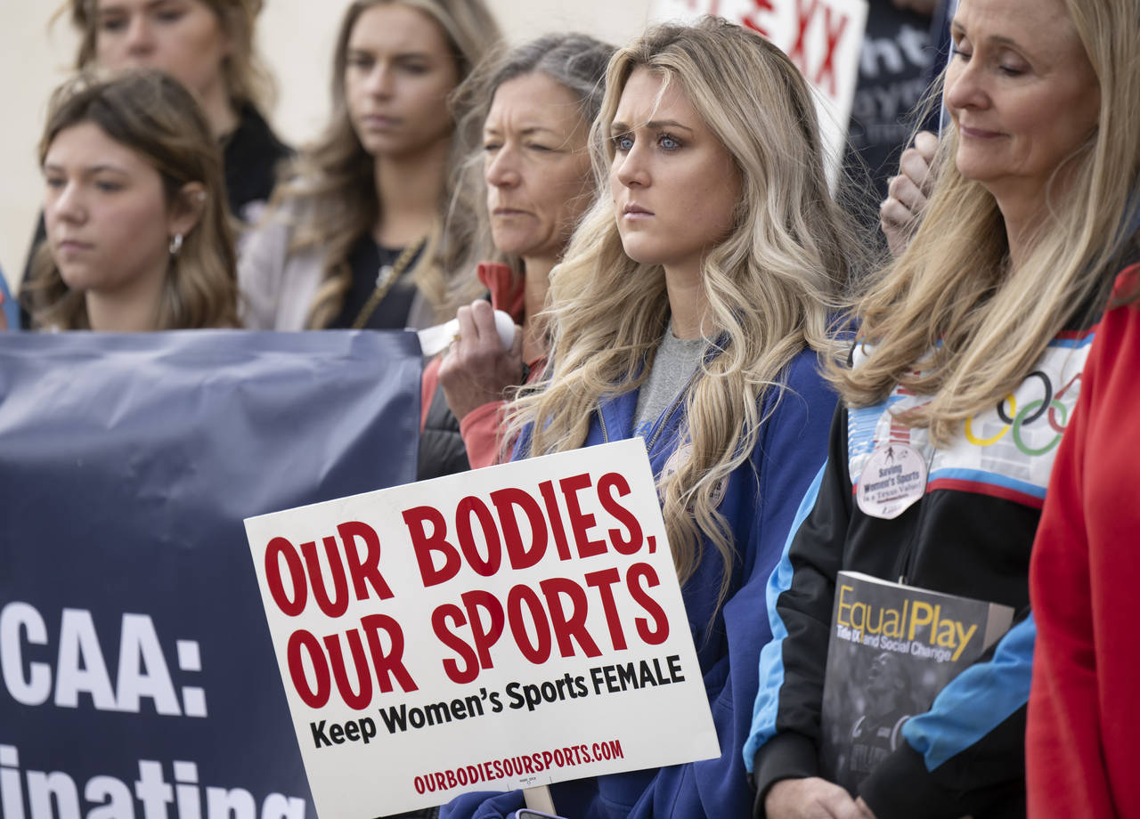 Former University of Kentucky swimmer Riley Gaines, second from right, stands during a rally on Thu...