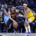 
              Atlanta Hawks' Trae Young (11) goes to the basket past Indiana Pacers' Andrew Nembhard during the first half of an NBA basketball game Friday, Jan. 13, 2023, in Indianapolis. (AP Photo/Darron Cummings)
            