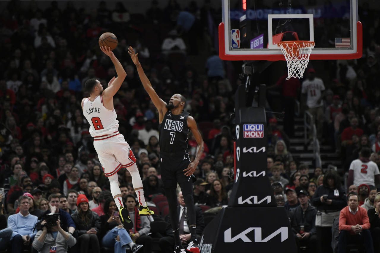 Chicago Bulls' Zach LaVine (8) shoots over Brooklyn Nets' Kevin Durant (7) during the first half of...