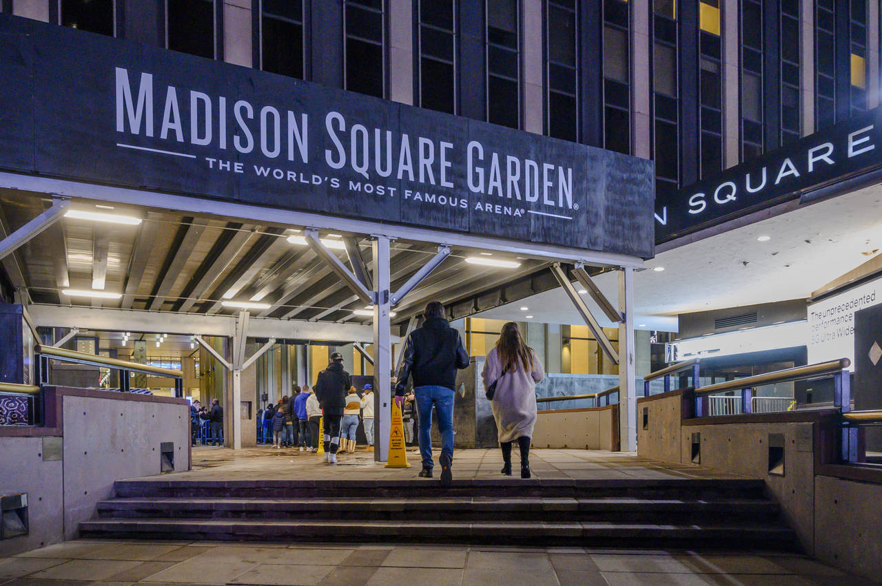 FILE - Fans line up outside Madison Square Garden before an NBA basketball game between the New Yor...