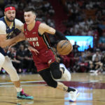 
              Miami Heat guard Tyler Herro (14) drives to the basket against New Orleans Pelicans forward Larry Nance Jr. during the first half of an NBA basketball game, Sunday, Jan. 22, 2023, in Miami. (AP Photo/Wilfredo Lee)
            