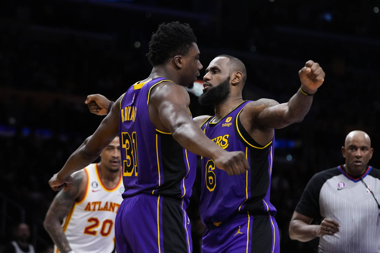 Los Angeles Lakers' Thomas Bryant (31) and LeBron James (6) celebrate after Bryant scored a basket ...