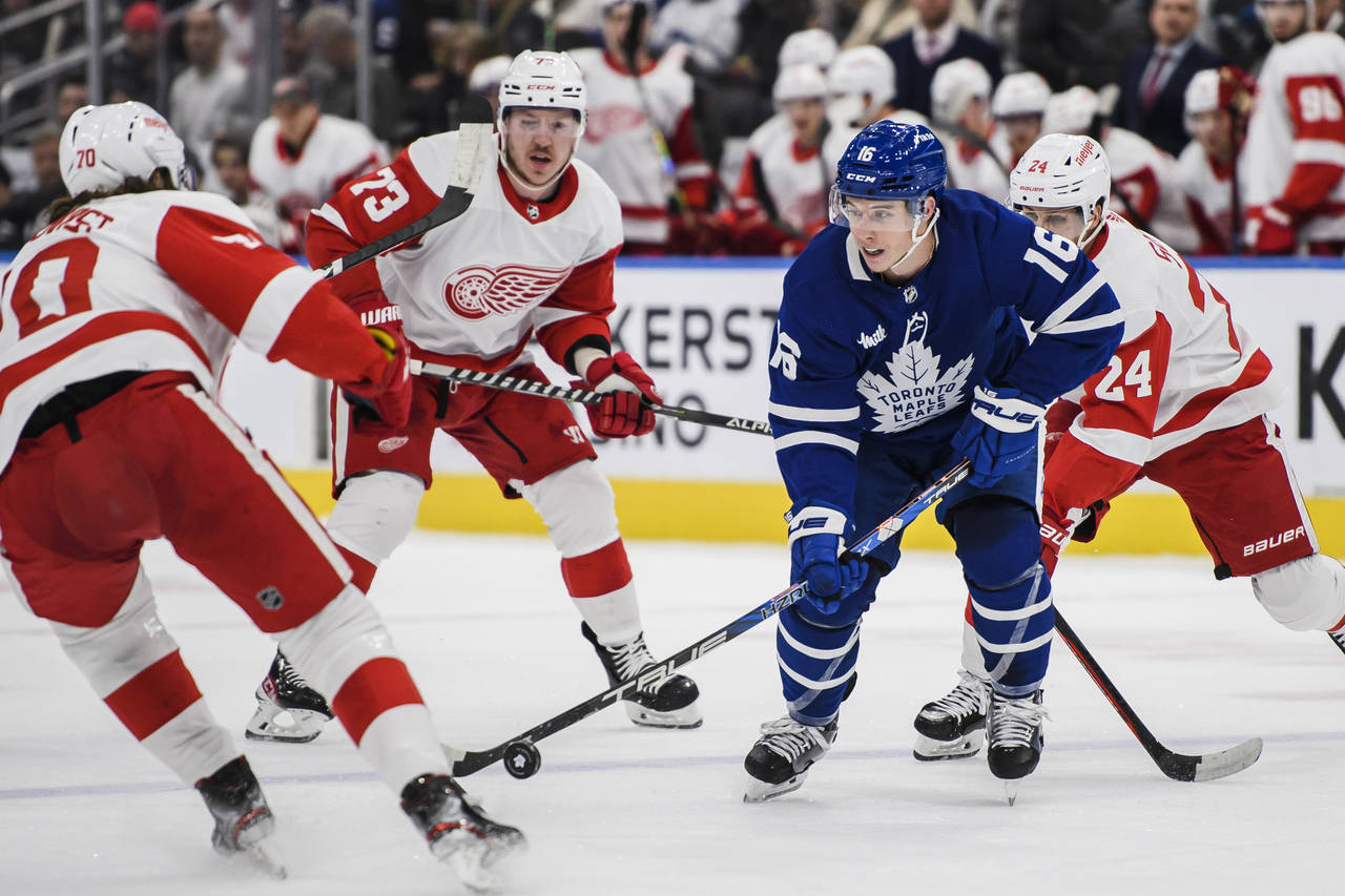 Toronto Maple Leafs right wing Mitchell Marner (16) controls the puck as Detroit Red Wings center O...