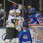 
              New York Rangers goaltender Jaroslav Halak (41) watches as Vegas Golden Knights right wing Phil Kessel (8) celebrates his goal with center William Karlsson (71) during the second period of an NHL hockey game Friday, Jan. 27, 2023, at Madison Square Garden in New York. (AP Photo/Mary Altaffer)
            