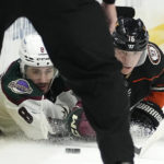 
              Arizona Coyotes center Nick Schmaltz, left, and Anaheim Ducks center Ryan Strome dive for the puck during the second period of an NHL hockey game Saturday, Jan. 28, 2023, in Anaheim, Calif. (AP Photo/Mark J. Terrill)
            