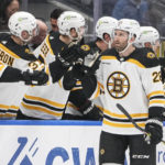 
              Boston Bruins' Derek Forbort (28) celebrates with teammates after scoring a goal during the second period of an NHL hockey game against the New York Islanders Wednesday, Jan. 18, 2023, in Elmont, N.Y. (AP Photo/Frank Franklin II)
            