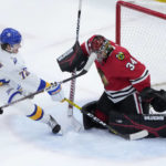 
              Chicago Blackhawks goaltender Petr Mrazek (34) makes a pad save on a shot by Buffalo Sabres' Tage Thompson during the third period of an NHL hockey game Tuesday, Jan. 17, 2023, in Chicago. The Blackhawks won 4-3 in overtime. (AP Photo/Charles Rex Arbogast)
            