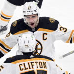 
              Boston Bruins' Patrice Bergeron (37) celebrates with teammate Connor Clifton after scoring against the Montreal Canadiens during the third period of an NHL hockey game in Montreal, Tuesday, Jan. 24, 2023. (Graham Hughes/The Canadian Press via AP)
            