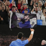 
              Novak Djokovic of Serbia gestures to his supporters after defeating Roberto Carballes Baena of Spain in their first round match at the Australian Open tennis championship in Melbourne, Australia, Wednesday, Jan. 18, 2023. (AP Photo/Aaron Favila)
            