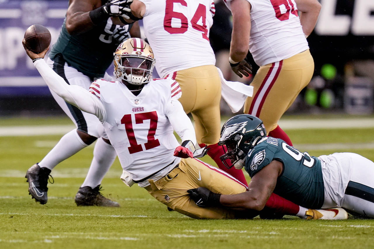 San Francisco 49ers quarterback Josh Johnson (17) passes while being tackled by Philadelphia Eagles...