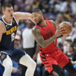 
              Portland Trail Blazers guard Damian Lillard, right, is defended by Denver Nuggets center Nikola Jokic during the second half of an NBA basketball game Tuesday, Jan. 17, 2023, in Denver. (AP Photo/David Zalubowski)
            