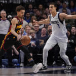 
              Atlanta Hawks guard Trae Young (11) drives against Dallas Mavericks center Dwight Powell (7) during the first quarter of an NBA basketball game in Dallas, Wednesday, Jan. 18, 2023. (AP Photo/LM Otero)
            