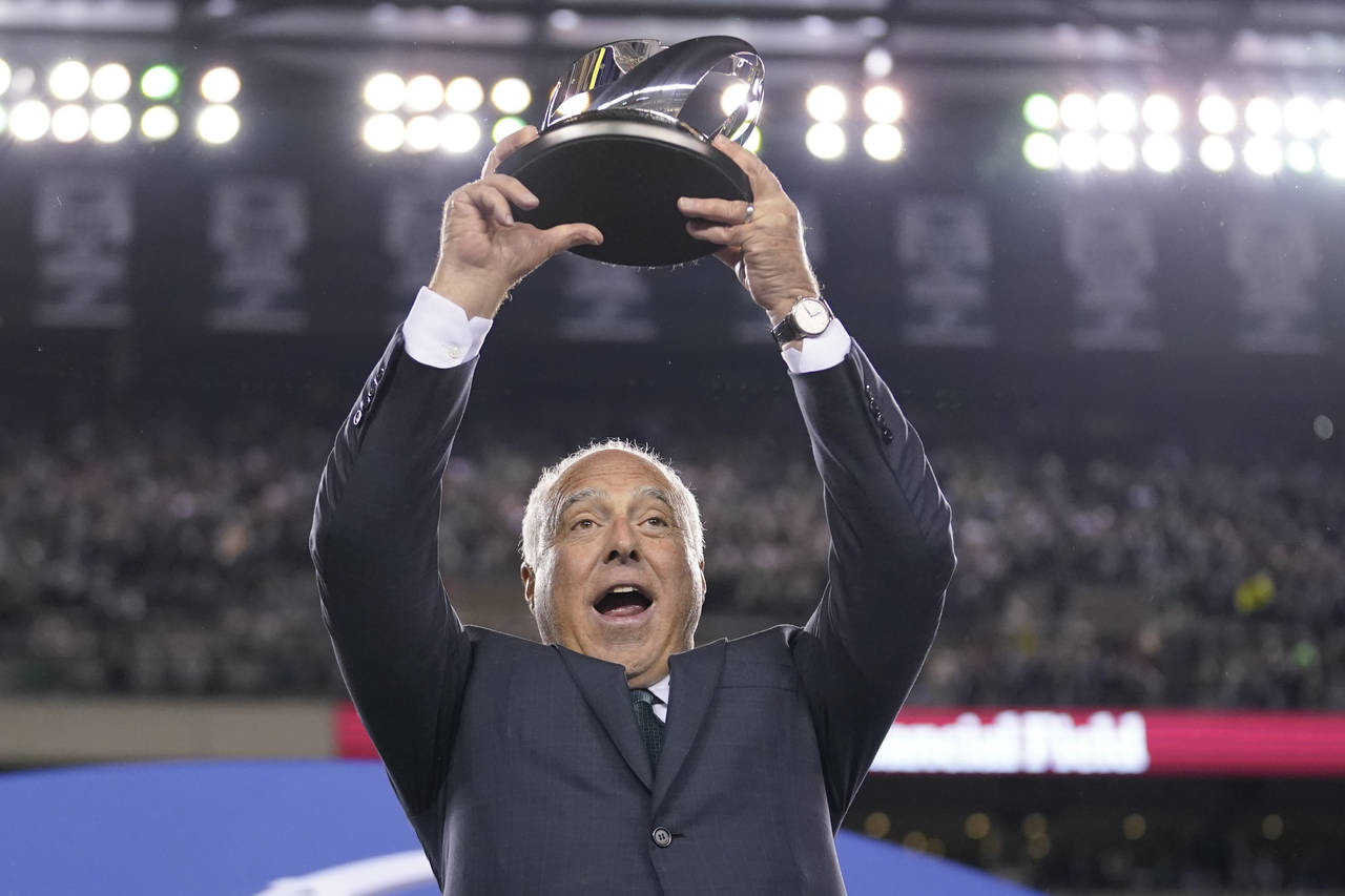Philadelphia Eagles owner Jeffrey Lurie hoists the George Halas Trophy after the NFC Championship N...