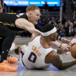 
              Golden State Warriors guard Donte DiVincenzo, left, and Phoenix Suns forward Torrey Craig (0) compete for possession of the ball during the second half of an NBA basketball game in San Francisco, Tuesday, Jan. 10, 2023. (AP Photo/Godofredo A. Vásquez)
            