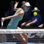 
              Magda Linette of Poland plays a backhand return to Caroline Garcia of France during their fourth round match at the Australian Open tennis championship in Melbourne, Australia, Monday, Jan. 23, 2023. (AP Photo/Aaron Favila)
            