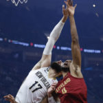 
              New Orleans Pelicans center Jonas Valanciunas (17) and Cleveland Cavaliers forward Evan Mobley (4) battle for a rebound during the first half of an NBA basketball game, Monday, Jan. 16, 2023, in Cleveland. (AP Photo/Ron Schwane)
            