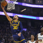
              Golden State Warriors guard Stephen Curry, left, shoots against the Memphis Grizzlies during the first half of an NBA basketball game in San Francisco, Wednesday, Jan. 25, 2023. (AP Photo/Godofredo A. Vásquez)
            
