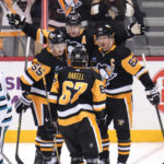 
              Pittsburgh Penguins' Evgeni Malkin celebrates with Sidney Crosby and Jake Guentzel after scoring during the first period of an NHL hockey game in Pittsburgh, Saturday, Jan. 28, 2023. (AP Photo/Gene J. Puskar)
            