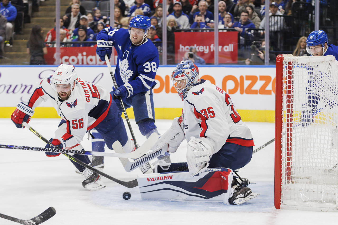 Toronto Maple Leafs defenseman Rasmus Sandin (38) looks for a rebound as Washington Capitals defens...