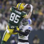 
              Green Bay Packers tight end Robert Tonyan (85) catches a pass as Detroit Lions safety DeShon Elliott defends during the first half of an NFL football game Sunday, Jan. 8, 2023, in Green Bay, Wis. (AP Photo/Matt Ludtke)
            