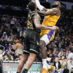 
              Los Angeles Lakers forward LeBron James shoots over Charlotte Hornets forward P.J. Washington during the first half of an NBA basketball game between the Charlotte Hornets and the Los Angeles Lakers on Monday, Jan. 2, 2023, in Charlotte, N.C. (AP Photo/Chris Carlson)
            