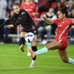 
              FILE - Portland Thorns FC forward Sophia Smith, left, kicks the ball against Kansas City Current defender Addisyn Merrick, right, during the first half of the NWSL championship soccer match, Saturday, Oct. 29, 2022, in Washington. Forward Sophia Smith was named the U.S. Soccer Female Player of the Year on Friday, Jan. 6, 2023, after leading the national team with 11 goals and starting in a team-high 17 matches. (AP Photo/Nick Wass, File)
            