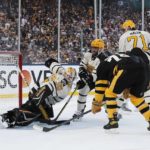 
              Pittsburgh Penguins goalie Tristan Jarry (35) deflects a shot in front of Boston Bruins' Jake DeBrusk (74) during the first period of the NHL Winter Classic hockey game, Monday, Jan. 2, 2023, at Fenway Park in Boston. (AP Photo/Michael Dwyer)
            