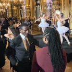 
              Detroit Pistons coach Dwayne Casey, center left, talks while ballet performers entertain during a reception at the Paris Opera house Tuesday night Jan. 17, 2023, in Paris France. The Detroit Pistons play the Chicago Bulls in Paris on Thursday.  (AP Photo/Tim Reynolds)
            