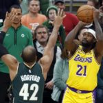 
              Los Angeles Lakers' Patrick Beverley (21) shoots against Boston Celtics' Al Horford (42) during the first half of an NBA basketball game, Saturday, Jan. 28, 2023, in Boston. (AP Photo/Michael Dwyer)
            