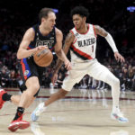 
              Detroit Pistons forward Bojan Bogdanovic, left, drives to the basket on Portland Trail Blazers guard Anfernee Simons during the second half of an NBA basketball game in Portland, Ore., Monday, Jan. 2, 2023. (AP Photo/Steve Dykes)
            