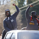
              Georgia defensive linemen Zion Logue, left, and Nazir Stackhouse, right, acknowledge the crowd during a parade celebrating the Bulldog's second consecutive NCAA college football national championship, Saturday, Jan. 14, 2023, in Athens, Ga. (AP Photo/Alex Slitz)
            