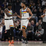 
              Minnesota Timberwolves guard Anthony Edwards, left, and forward Kyle Anderson (5) celebrate after a basket during the first half of an NBA basketball game against the Phoenix Suns, Friday, Jan. 13, 2023, in Minneapolis. (AP Photo/Abbie Parr)
            