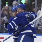 
              Toronto Maple Leafs centerJohn Tavares (91) celebrates after his goal against the New York Islanders with teammate William Nylander (88) during second-period NHL hockey game action in Toronto, Ontario, Monday, Jan. 23, 2023. (Nathan Denette/The Canadian Press via AP)
            
