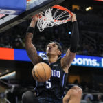 
              Orlando Magic's Paolo Banchero makes an uncontested dunk against the Boston Celtics during the second half of an NBA basketball game, Monday, Jan. 23, 2023, in Orlando, Fla. (AP Photo/John Raoux)
            