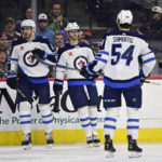 
              Winnipeg Jets' Kyle Connor, center, celebrates after his goal with teammates Pierre-Luc Dubois and Dylan Samberg (54) during the first period of an NHL hockey game against the Philadelphia Flyers, Sunday, Jan. 22, 2023, in Philadelphia. (AP Photo/Derik Hamilton)
            