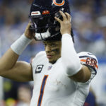 
              Chicago Bears quarterback Justin Fields puts on his helmet during the second half of an NFL football game against the Detroit Lions, Sunday, Jan. 1, 2023, in Detroit. (AP Photo/Duane Burleson)
            
