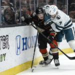 
              Anaheim Ducks defenseman Colton White (45) protects the puck from San Jose Sharks center Nico Sturm (7) during the second period of an NHL hockey game in Anaheim, Calif., Friday, Jan. 6, 2023. (AP Photo/Kyusung Gong)
            