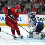 
              Winnipeg Jets goaltender Connor Hellebuyck (37) stops a Detroit Red Wings center Joe Veleno (90) shot in the second period of an NHL hockey game Tuesday, Jan. 10, 2023, in Detroit. (AP Photo/Paul Sancya)
            