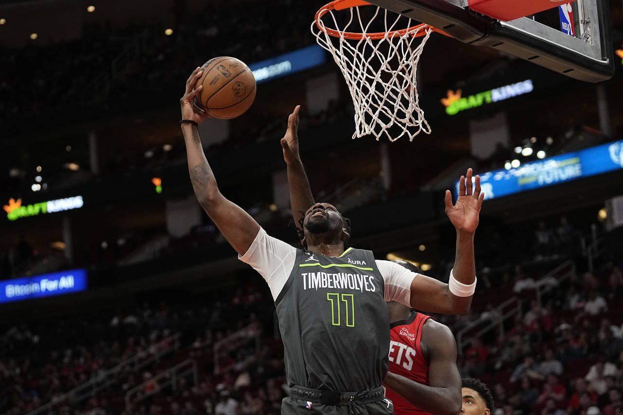 Minnesota Timberwolves' Naz Reid (11) shoots against the Houston Rockets during the first half of a...
