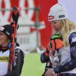 
              United States' Mikaela Shiffrin, right, winner of an alpine ski, women's World Cup giant slalom race, is overcome by emotion as she listens to the national anthem on the podium with second-placed Italy's Federica Brignone, left, in Kranjska Gora, Slovenia, Sunday, Jan. 8, 2023. Shiffrin matched Lindsey Vonn's women's World Cup skiing record with her 82nd win Sunday. (AP Photo/Marco Trovati)
            