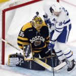 
              Toronto Maple Leafs' Auston Matthews (34) pressures Boston Bruins' Linus Ullmark (35) as a shot by Michael Bunting goes into the net during the first period of an NHL hockey game Saturday, Jan. 14, 2023, in Boston. (AP Photo/Michael Dwyer)
            