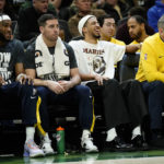 
              Indiana Pacers' Tyrese Haliburton, right, laughs from the bench while wearing a shirt honoring Martin Luther King Jr. during the first half of an NBA basketball game against the Milwaukee Bucks, Monday, Jan. 16, 2023, in Milwaukee. (AP Photo/Aaron Gash)
            