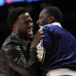 
              Comedian Kevin Hart, left, laughs with sports agent Rich Paul during the first half of an NBA basketball game between the Memphis Grizzlies and the Los Angeles Lakers in Los Angeles, Friday, Jan. 20, 2023. (AP Photo/Ashley Landis)
            