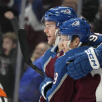 
              Colorado Avalanche right wing Mikko Rantanen, front left, celebrates with center Nathan MacKinnon after scoring a goal in the first period of an NHL hockey game against the Ottawa Senators, Saturday, Jan. 14, 2023, in Denver. (AP Photo/David Zalubowski)
            