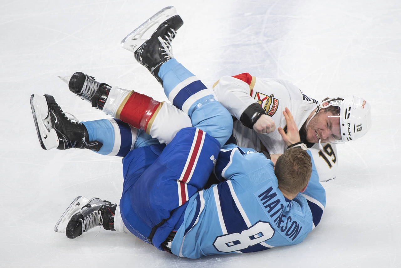 Florida Panthers' Matthew Tkachuk (19) fights with Montreal Canadiens' Mike Matheson during the thi...